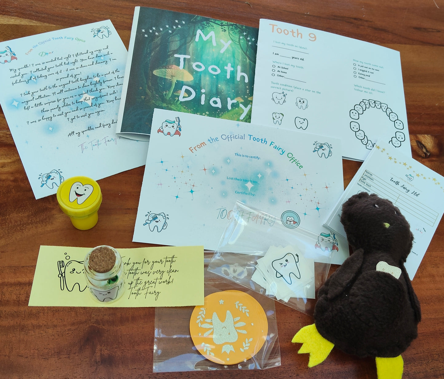 Collection of items related to a tooth fairy kit including, Kiwi Lost Tooth, Tooth Fairy  pillow, letter and tooth fairy certificate. 