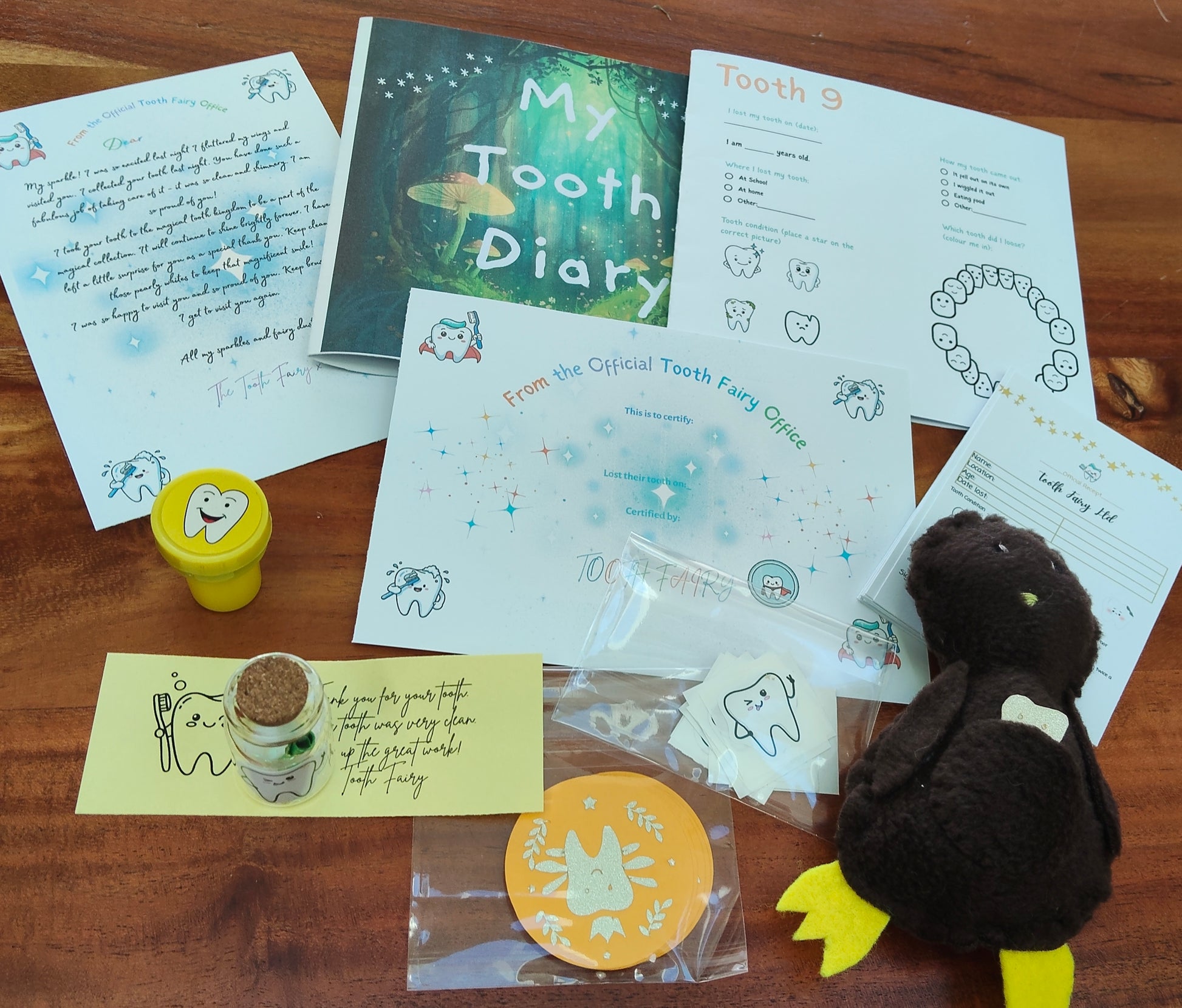Collection of items related to a tooth fairy kit including, Kiwi Lost Tooth, Tooth Fairy  pillow, letter and tooth fairy certificate. 