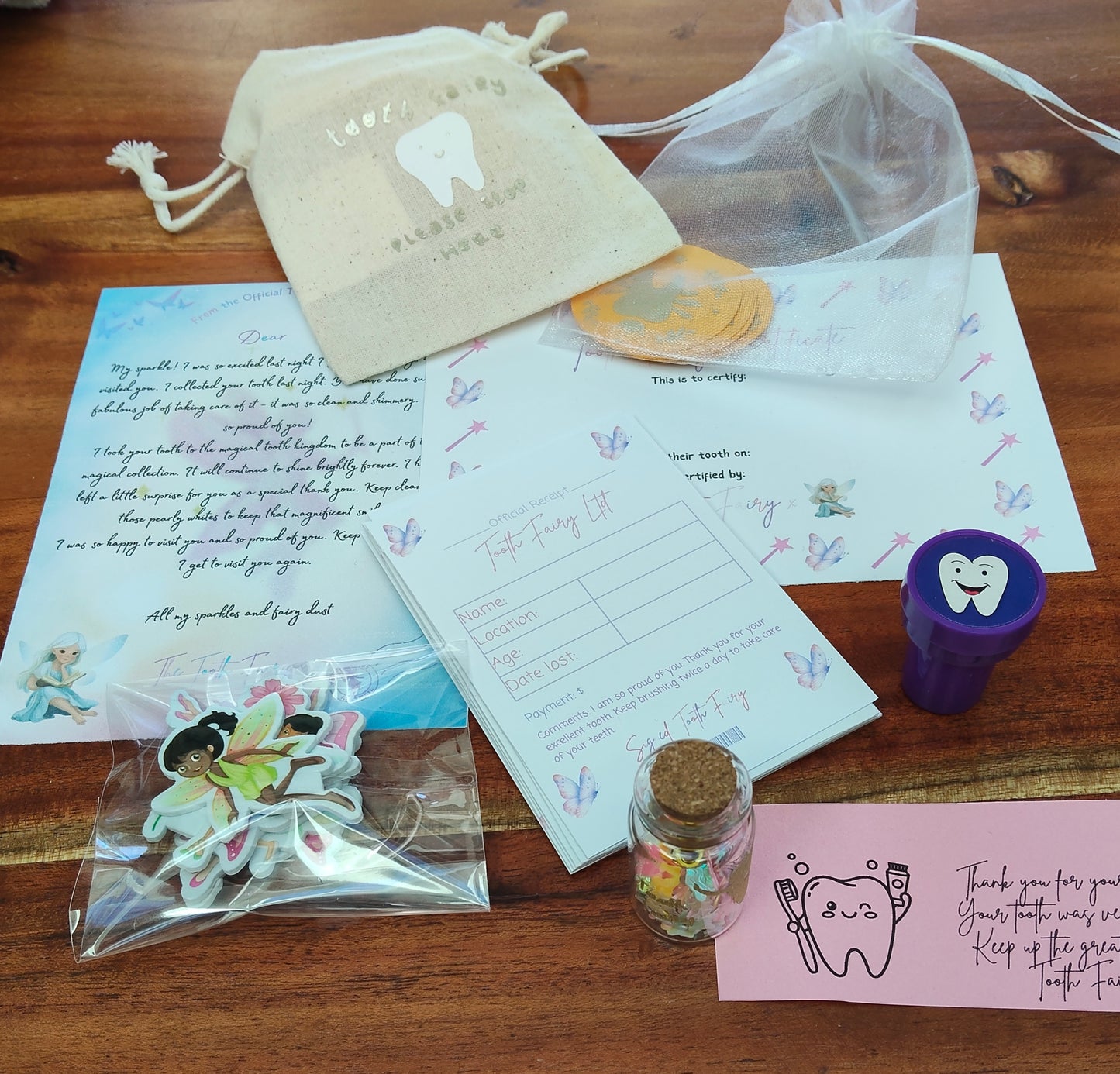 Lost Tooth, Tooth Fairy Kit includes Tooth Fairy Receipts, message in a bottle, tooth fairy letter, certificate and small tooth fairy gifts in a pink blush colour