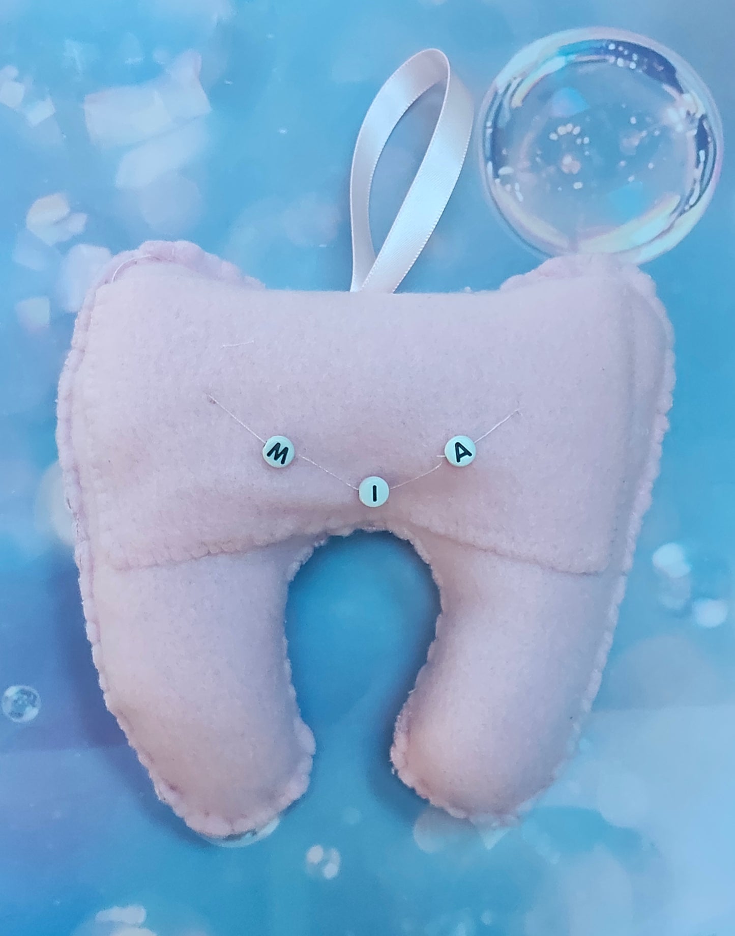 Pink tooth-shaped plush, lost tooth, tooth fairy pouch with a cute face. Personalised name pouch made with beads. 