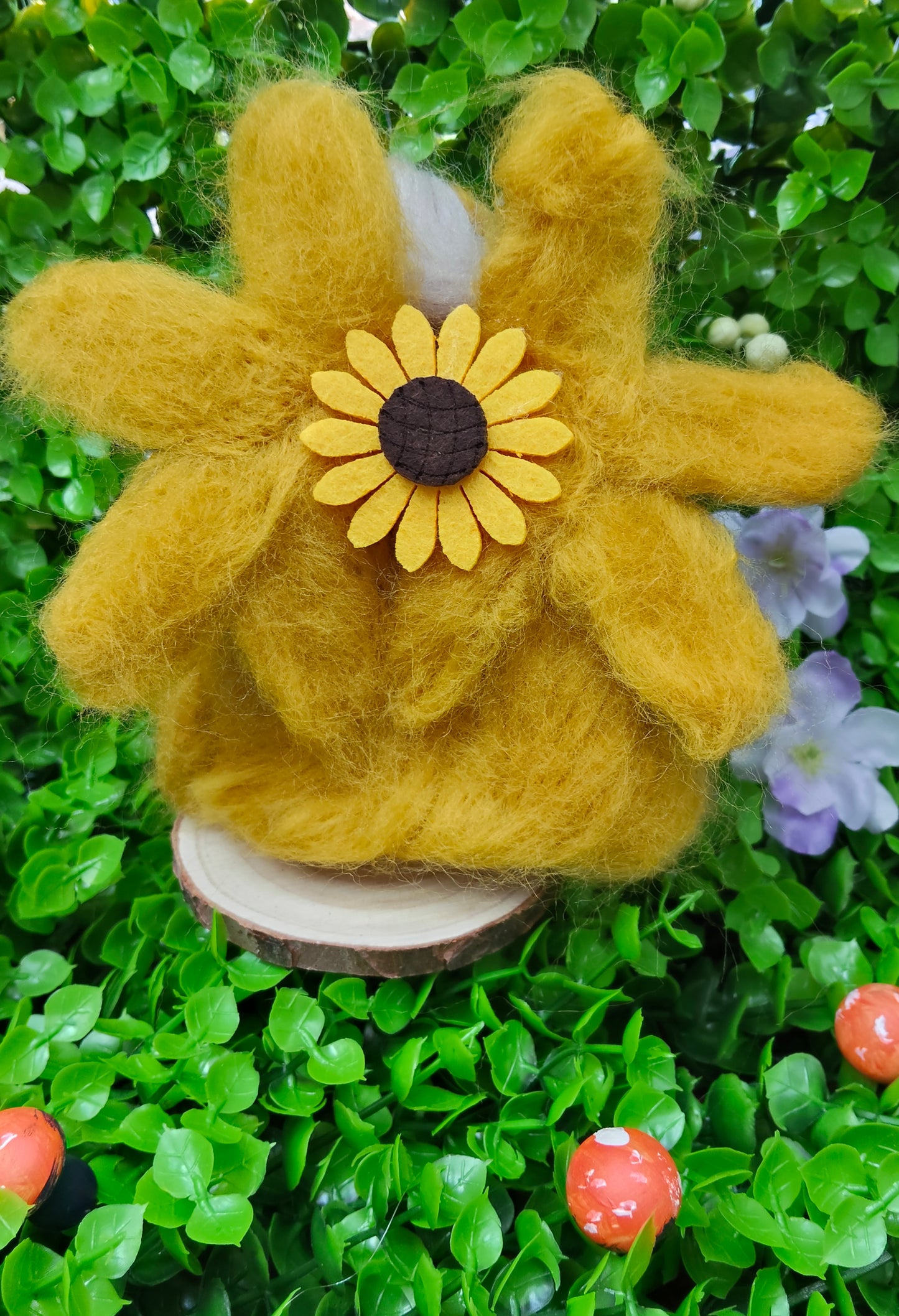 Yellow needle felted fairy with a sunflower design, complete with pearl decorations on a personalised name, wooden round stand. 
