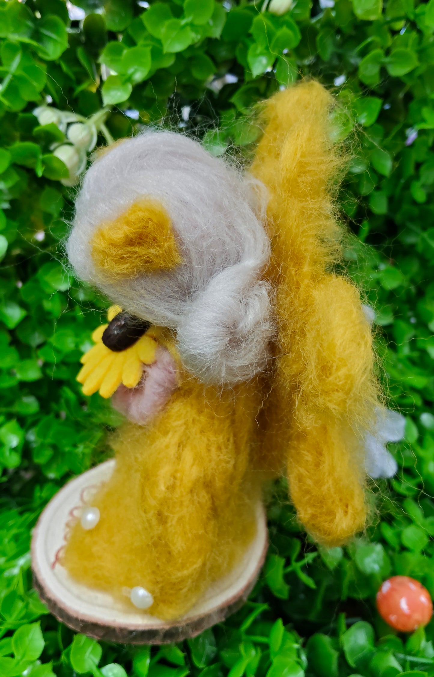 Yellow needle felted fairy with a sunflower design, complete with pearl decorations on a personalised name, wooden round stand. 