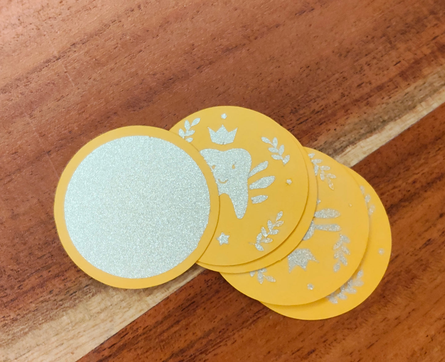 Glittery tooth fairy money coins on gold card