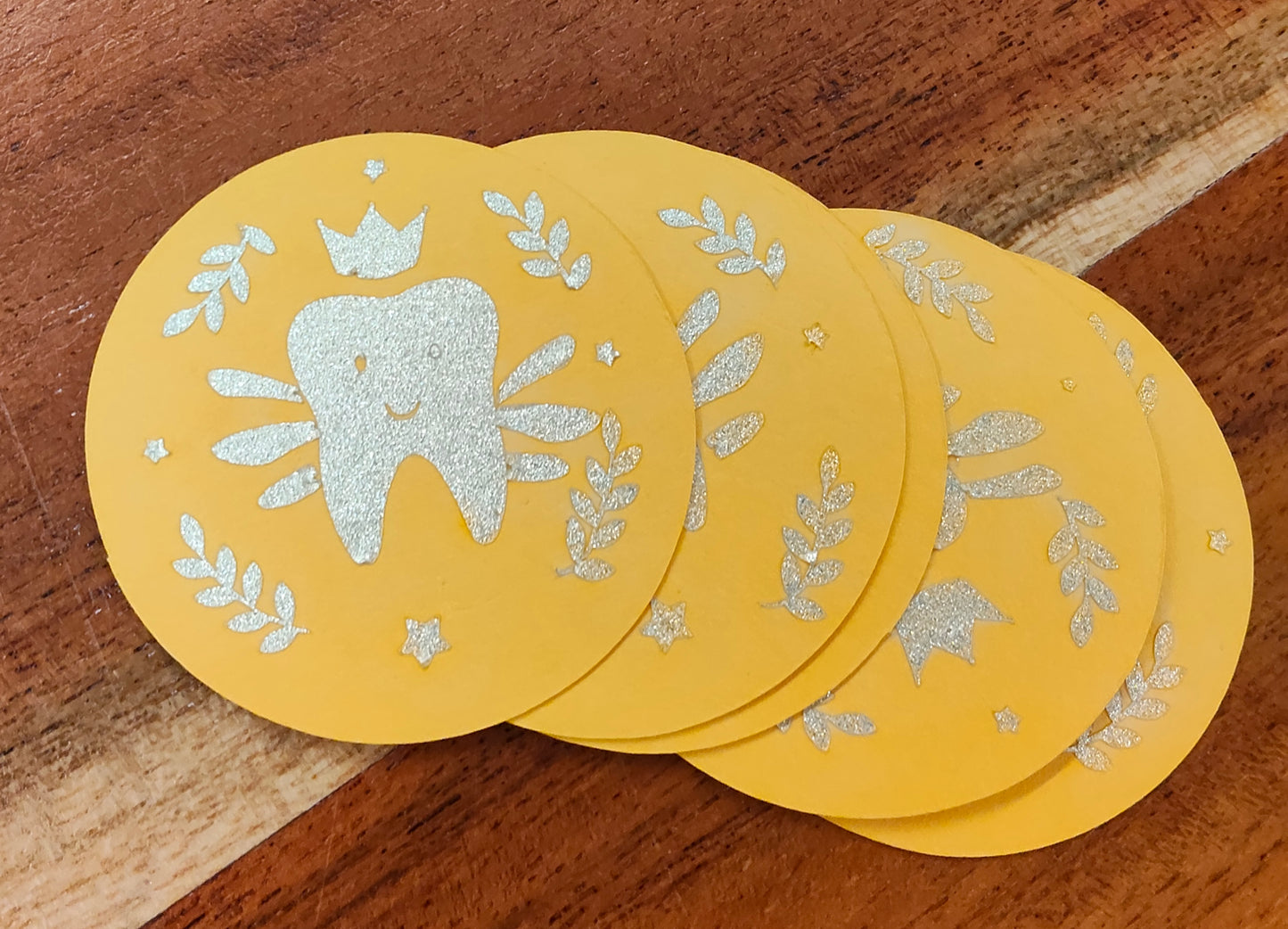 Glittery tooth fairy money coins on gold card